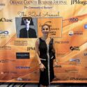 Anoosheh Mostafaei-Oskouian standing in front of the Orange County Business Journal 32nd Annual Women in Business Awards backdrop