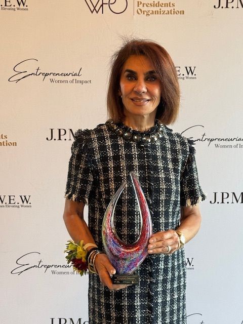 Anoosheh Oskouian holding the 2026 Entrepreneurial Women of Impact Award